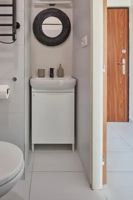 a bathroom with a sink and a mirror and a toilet at Prague Days - Old Town Square Apartments in Prague