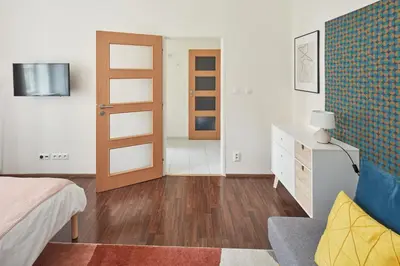 a bedroom with a bed and a room with a door at Prague Days - Old Town Square Apartments in Prague
