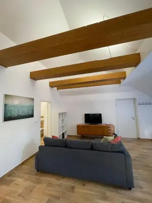 a living room with a couch and a tv at Kersko Apartments in Hradišťko