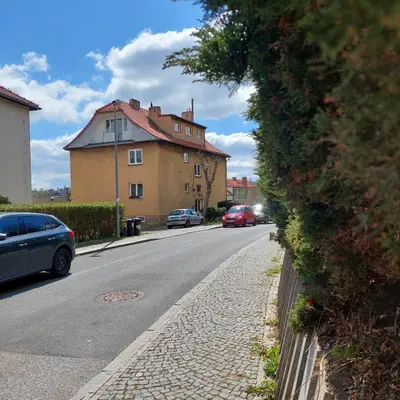 a street with cars parked on the side of the road at View of Prague in Prague
