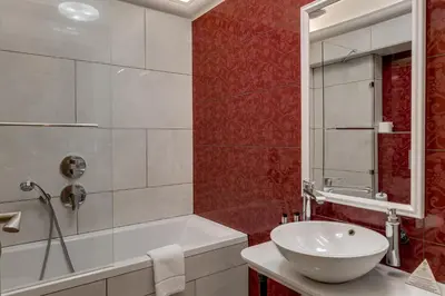 a bathroom with a tub and a sink and a shower at Louren - The Bridge Inn in Prague