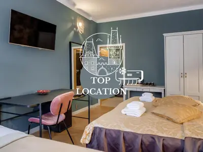 a bedroom with a top location sticker on the wall at Louren - The Bridge Inn in Prague