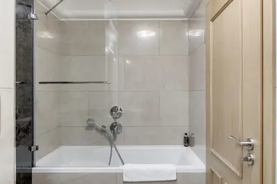 a bathroom with a shower with a bath tub at Louren - The Bridge Inn in Prague