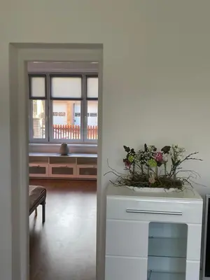 a living room with a table with flowers on it at Apartmán Na Polabí in Mělník