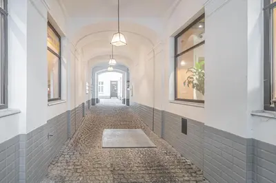 an empty hallway with a cobblestone alley with windows at Útulny byt v centru Prahy in Prague