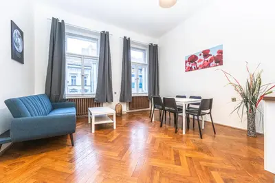 a living room with a table and chairs at Legerova Apartments in Prague