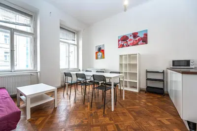 a kitchen and dining room with tables and chairs at Legerova Apartments in Prague