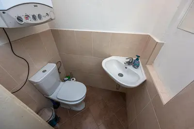 a small bathroom with a toilet and a sink at Legerova Apartments in Prague