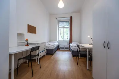 a room with a desk and a bed and a table at Legerova Apartments in Prague