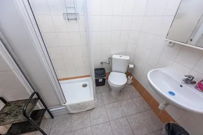 a small bathroom with a toilet and a sink at Legerova Apartments in Prague