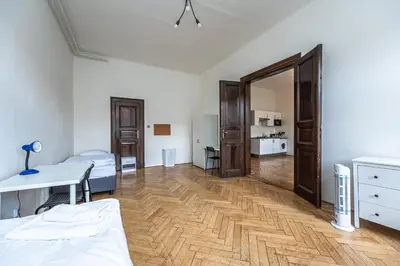 a room with a bed and a desk and a mirror at Legerova Apartments in Prague