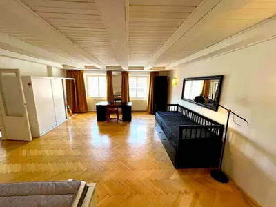 a living room with a couch and wooden floors at Kristian's Old Town Sq. Apartments in Prague