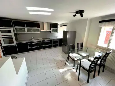 a kitchen with a table and chairs and a refrigerator at Kristian's Old Town Sq. Apartments in Prague