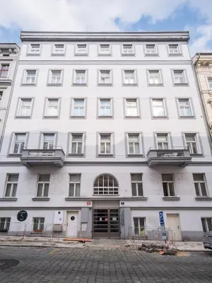 a kitchen with a counter with chairs and a sink at Prague Days - Loft with Garage and Workspace right next to Wenceslas Square in Prague