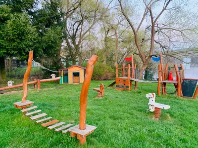 a playground with play equipment in the grass at Apartmány Županovice in Dobříš