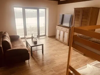 a living room with a couch and a television at Apartmány Županovice in Dobříš