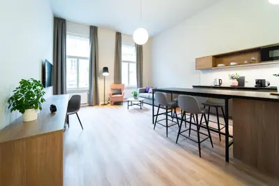 a bedroom with a large white bed and a window at Karl BY ZEITRAUM in Prague