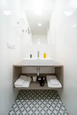 a bathroom with a sink and a counter with towels at Karl BY ZEITRAUM in Prague