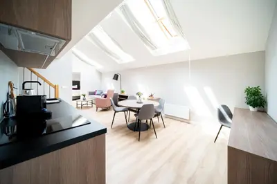 an attic kitchen and dining room with a skylight at Karl BY ZEITRAUM in Prague