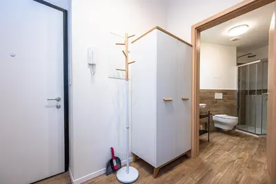 a bathroom with a glass shower and a toilet at Folimanka Apartments in Prague