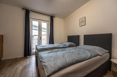 two beds in a room with a window at Folimanka Apartments in Prague