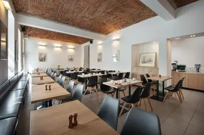 a restaurant with tables and chairs in a room at Prague Season Three Stars in Prague
