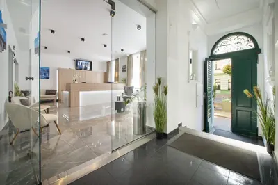 a living room with a green door and a dining room at Prague Season Three Stars in Prague