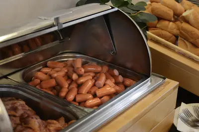 a tray of hot dogs in a buffet at Prague Season Three Stars in Prague