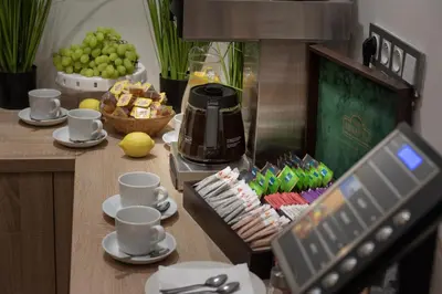 a table with cups and a coffee maker and food at Prague Season Three Stars in Prague