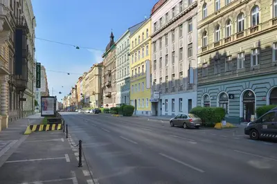 an empty street in a city with buildings at Prague Season Three Stars in Prague