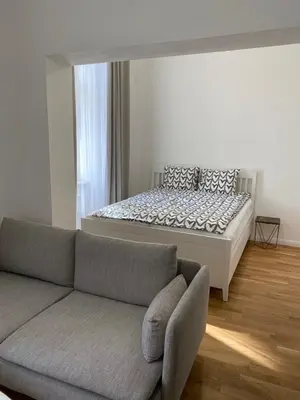 a living room with a couch and a bed at Angelo Roma in Prague