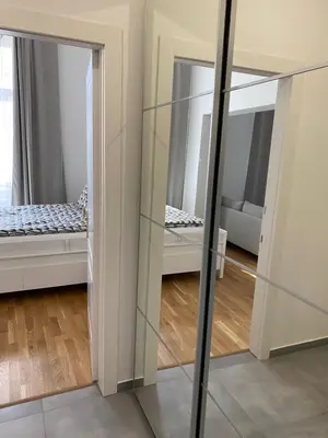 a mirror in a room with a bed in a room at Angelo Roma in Prague