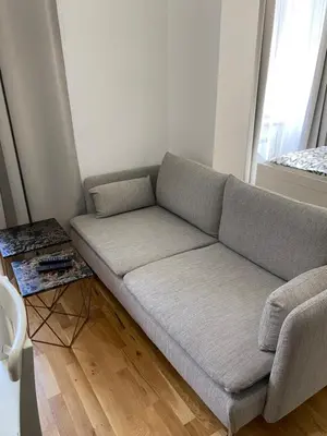 a couch in a living room with a table at Angelo Roma in Prague