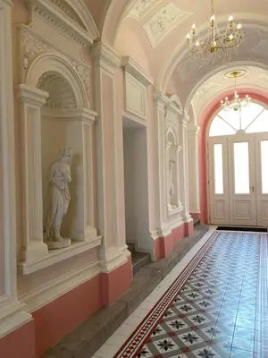 a large room with a statue in the middle of a hallway at Angelo Roma in Prague
