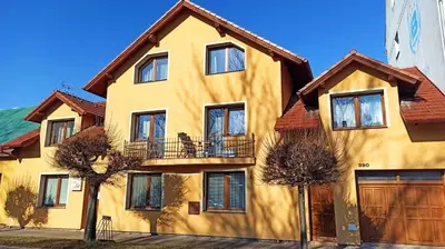 a yellow house with a brown roof at Apartmán Poděbrady in Poděbrady