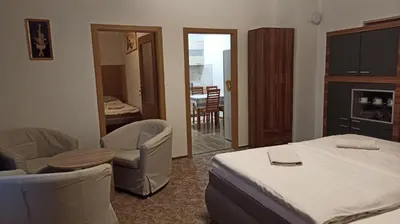 a hotel room with a bed and a table and chairs at Apartmán Poděbrady in Poděbrady