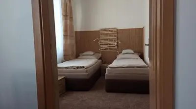 a small room with two beds and a window at Apartmán Poděbrady in Poděbrady