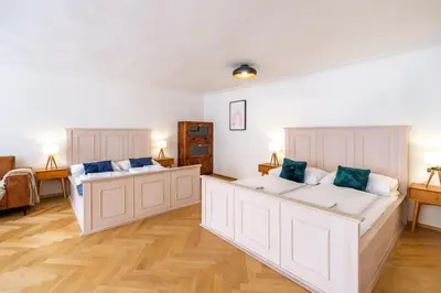 a room with two large beds in it at Celetná - Old Town Residence in Prague