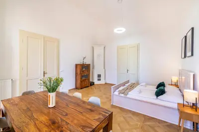 a large room with a bed and a table at Celetná - Old Town Residence in Prague
