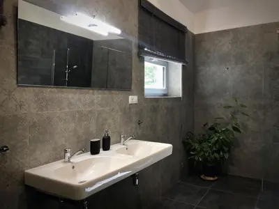 a bathroom with a sink and a mirror at Mezonetový apartmán s terasou na samotě v lese in Vlkava
