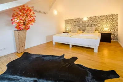 a bedroom with a bed and a vase with a plant at Historic Centre Apartments I in Prague