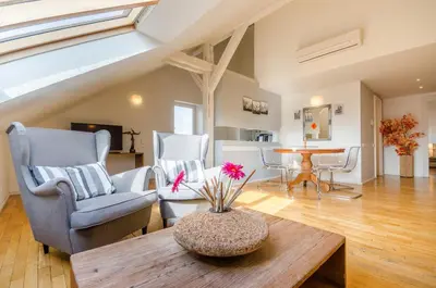 a living room with two chairs and a table at Historic Centre Apartments I in Prague