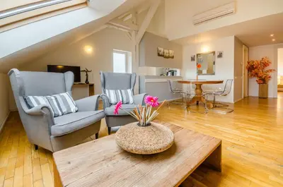 a living room with two chairs and a table at Historic Centre Apartments I in Prague
