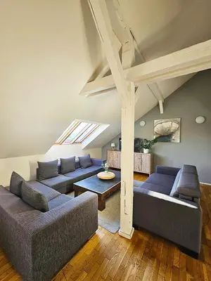 a living room with blue couches and a table at Historic Centre Apartments I in Prague