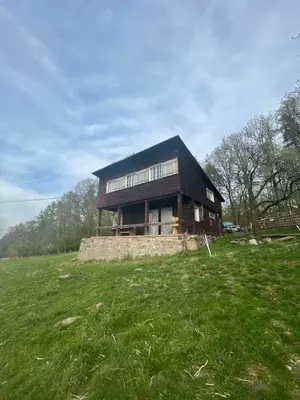 a house sitting on top of a grass field at Chata s duší in Beroun