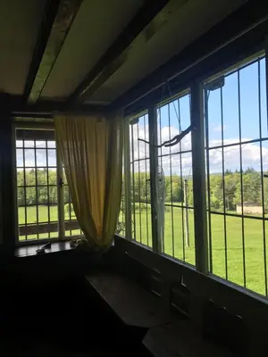 a room with windows with a view of a field at Chata s duší in Beroun