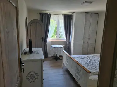 a small bedroom with a bed and a window at Airport Rooms in Prague