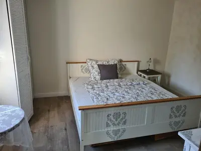 a bedroom with a large white bed with pillows at Airport Rooms in Prague