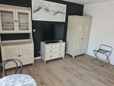 a living room with a tv and a dresser and a tvicterictericter at Airport Rooms in Prague
