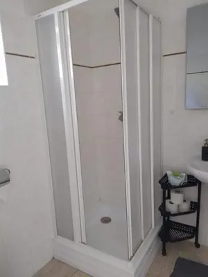 a shower stall in a bathroom with a sink at Apartmán 10 in Županovice